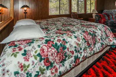 a bedroom with a bed with a floral bedspread at Makin' Memories At Summit-1683 by Big Bear Vacations in Big Bear Lake