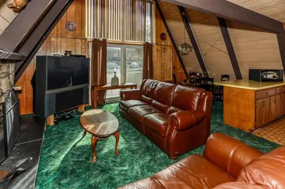 a living room with a leather couch and a television at Makin' Memories At Summit-1683 by Big Bear Vacations in Big Bear Lake