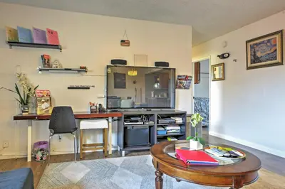 a living room with a table and a kitchen at 3 Mi to Dtwn Dining! Long Beach Condo with Balcony in Long Beach