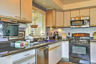 a large kitchen with white cabinets and appliances at Unique Long Beach House with Patio, Grill and Balcony in Long Beach