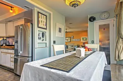 a kitchen with a table and a refrigerator at Unique Long Beach House with Patio, Grill and Balcony in Long Beach