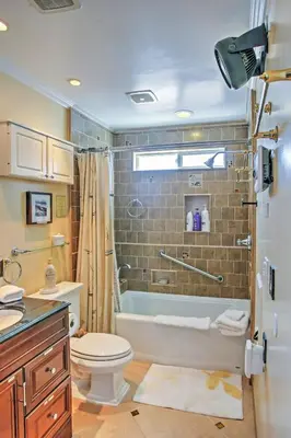 a bathroom with a tub and a toilet and a sink at Unique Long Beach House with Patio, Grill and Balcony in Long Beach