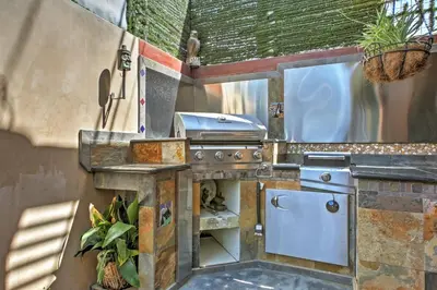 an outdoor kitchen with a stove and a sink at Unique Long Beach House with Patio, Grill and Balcony in Long Beach