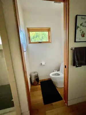 a bathroom with a toilet and a window at Del Rey/Culver City Dream Oasis in Los Angeles