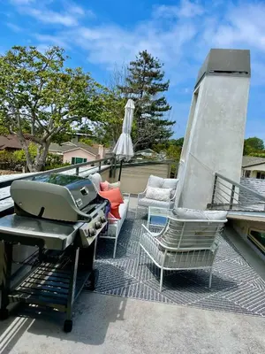a barbecue grill and chairs on a patio at Del Rey/Culver City Dream Oasis in Los Angeles