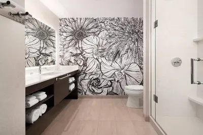 a bathroom with a black and white flower wallpaper at Residence Inn Los Angeles Glendale in Glendale