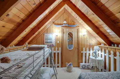 a attic room with a bed and a wooden ceiling at Mountain Tops Ponderosa Getaway Near Dome Rock! in Ponderosa