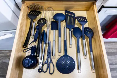 a wooden tray filled with forks and spoons and spatulas at Long Beach Duplex King Bed Pet Friendly Nurses Surgeon Business Travelers Near St Marys Medical Center & Downtown in Long Beach