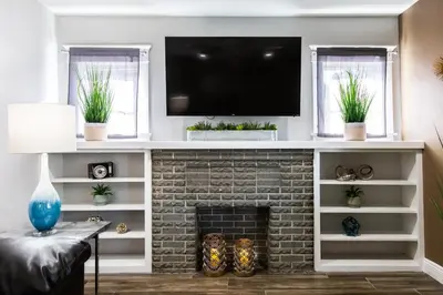 a living room with a fireplace with a tv above it at Long Beach Duplex King Bed Pet Friendly Nurses Surgeon Business Travelers Near St Marys Medical Center & Downtown in Long Beach