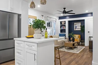 a kitchen and living room with a white counter top at Newly Renovated Gem Mins to Convention Center, Beaches and Downtown LB A in Long Beach