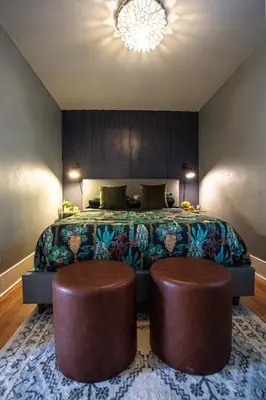 a bedroom with a bed with two ottomans at Newly Renovated Gem Mins to Convention Center, Beaches and Downtown LB A in Long Beach