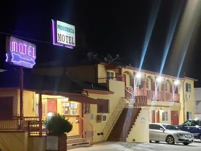 a sign on the side of a hotel at night at Providencia Motel in Burbank
