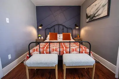 a bedroom with a bed with orange pillows and two chairs at Pet-Friendly Stay, Mins to Beach, Conv Ctr, Prkg LB B in Long Beach
