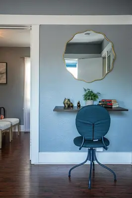 a chair in a room with a mirror on the wall at Pet-Friendly Stay, Mins to Beach, Conv Ctr, Prkg LB B in Long Beach