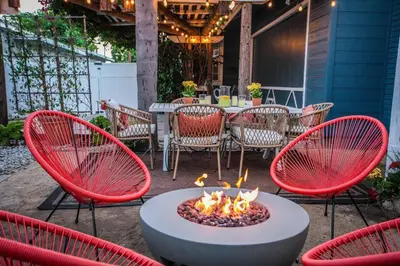 a patio with a fire pit with chairs and a table at Traveler's Pick Cozy, Near Beach & Dtwn,Prkg LB C in Long Beach