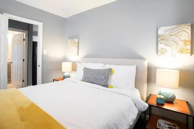 a bedroom with a large white bed and two lamps at Traveler's Pick Cozy, Near Beach & Dtwn,Prkg LB C in Long Beach