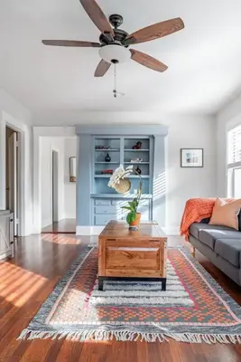 a living room with a ceiling fan and a coffee table at Historic Hm Mins to Beach, Convention Ctr Parking LB E in Long Beach