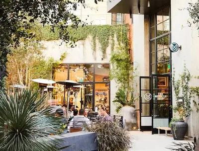 a group of people sitting outside of a restaurant at Stylish Hm Near Beach, Restaurants & Parking CC A in Los Angeles