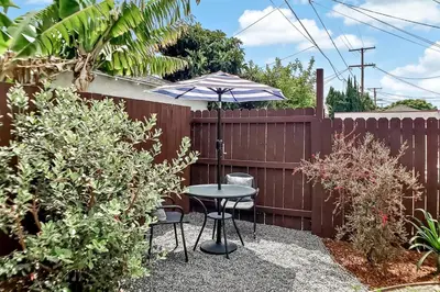 a patio with a table and an umbrella at Stylish Hm Near Beach, Restaurants & Parking CC A in Los Angeles