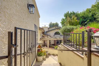 a gate to a house with flowers and plants at Chic Peaceful Retreat 16 Mi to Beaches and Wineries! in Santa Paula