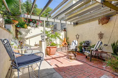 an outdoor patio with chairs and tables and awning at Chic Peaceful Retreat 16 Mi to Beaches and Wineries! in Santa Paula