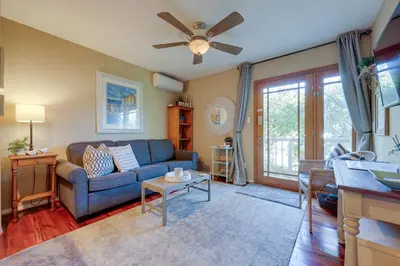 a living room with a blue couch and a ceiling fan at Chic Peaceful Retreat 16 Mi to Beaches and Wineries! in Santa Paula