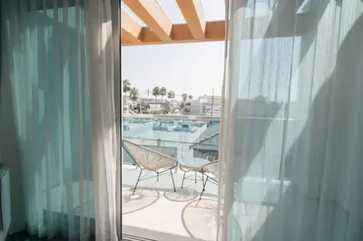 a balcony with a table and a chair on a balcony at H2O Hermosa Beach Hotel in Hermosa Beach
