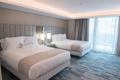 a hotel room with two beds and a large window at H2O Hermosa Beach Hotel in Hermosa Beach
