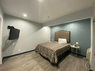 a bedroom with a bed and a flat screen tv at Motel 66 Los Angeles in Los Angeles