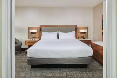 a bedroom with a large bed with two night stands and two lamps at Doubletree By Hilton Fullerton in Fullerton
