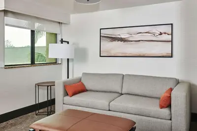 a living room with a couch and a table at Doubletree By Hilton Fullerton in Fullerton