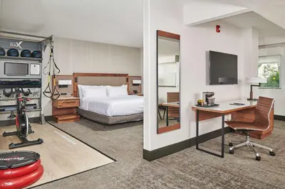a hotel room with a bed and a desk with a computer at Doubletree By Hilton Fullerton in Fullerton