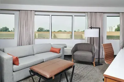 a living room with a couch and a chair at Doubletree By Hilton Fullerton in Fullerton