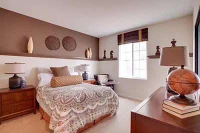 a bedroom with a bed and a desk with a globe on it at Single-Story San Bernardino Home with Valley Views! in San Bernardino