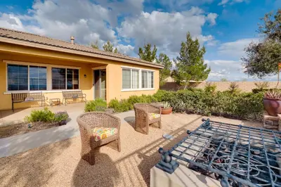 a patio with wicker chairs and a grill at Single-Story San Bernardino Home with Valley Views! in San Bernardino