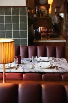 a table in a restaurant with plates and forks at The Hoxton, Downtown LA in Los Angeles