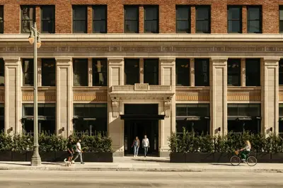 a large brick building with people in front of it at The Hoxton, Downtown LA in Los Angeles