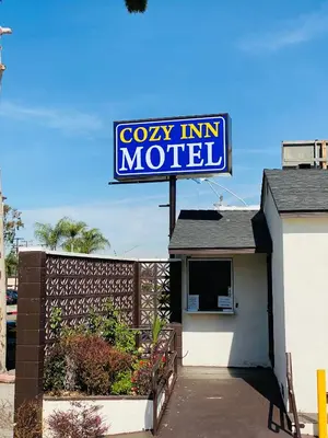 a cosy inn motel sign on top of a building at Cozy motel in Lynwood