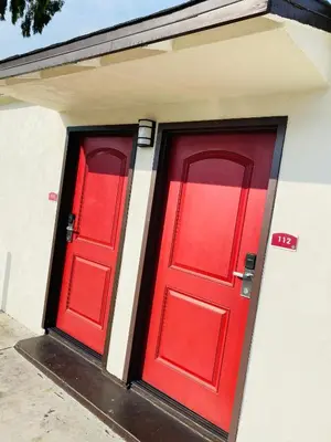 two red doors on the side of a building at Cozy motel in Lynwood