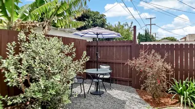 a patio with a table and an umbrella at Top Pick Apartment Near Grocery Store Parking CCD in Culver City