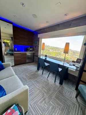 a living room with a table and a large window at HOLLYWOOD HILLS JETLINER VIEWS at STUDIO 1080 HOLLYWOOD in Los Angeles