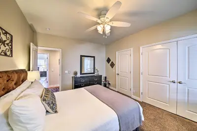 a bedroom with a bed and a ceiling fan at Mountain Gem with Game Room, 5 Mi to Lake Arrowhead! in Lake Arrowhead