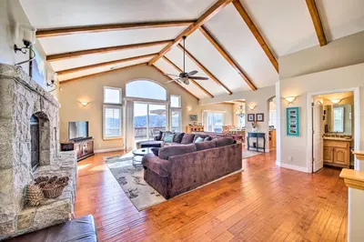 a living room with a couch and a fireplace at Mountain Gem with Game Room, 5 Mi to Lake Arrowhead! in Lake Arrowhead