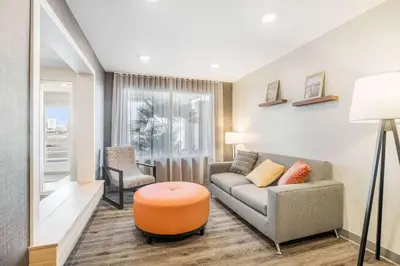 a living room with a couch and a chair at WoodSpring Suites Colton in Colton