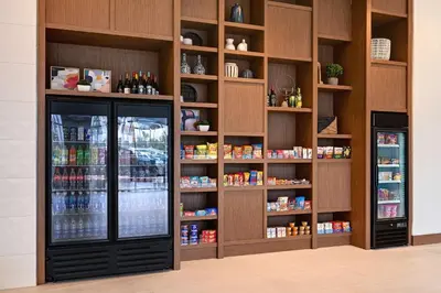 a grocery store with a refrigerator and shelves of food at Hilton Garden Inn Anaheim Resort in Anaheim