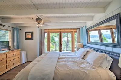a bedroom with a large bed with a window at Lakeview Lodge Fit for Groups Less Than 1 Mile to Lake! in Lake Arrowhead