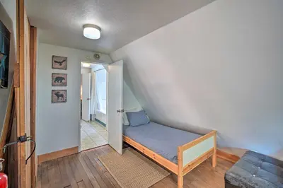 a small room with a blue bed in a room at Lakeview Lodge Fit for Groups Less Than 1 Mile to Lake! in Lake Arrowhead