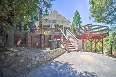 a house with a deck and a staircase and a fence at Lakeview Lodge Fit for Groups Less Than 1 Mile to Lake! in Lake Arrowhead