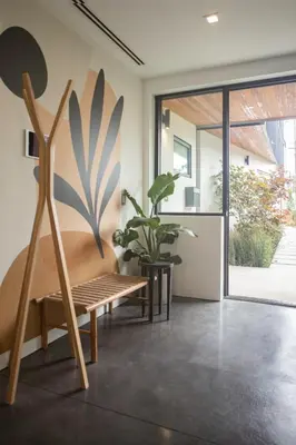 a living room with a bench and a plant at Haven Coliving in Los Angeles