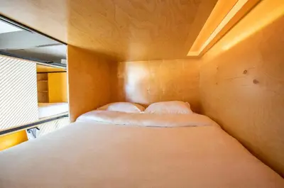 a small bedroom with two beds in it at Haven Coliving in Los Angeles